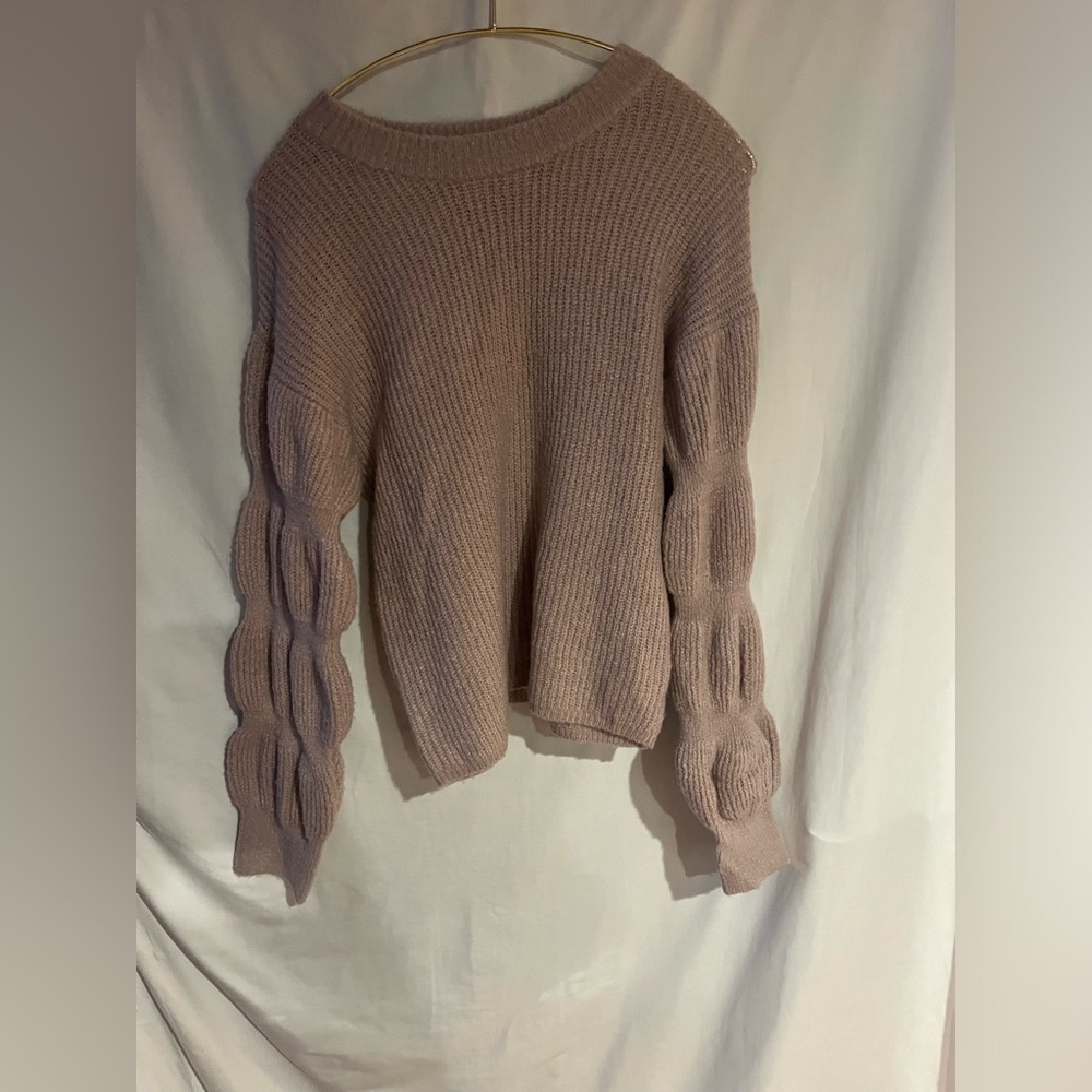 And now this, pink knitted sweater, ruffled sleeved